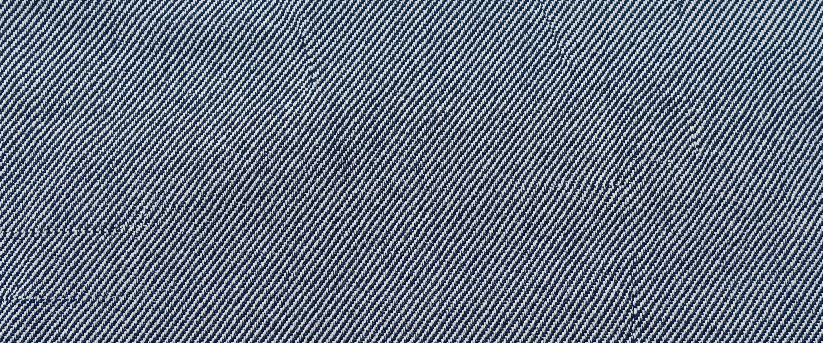 Full-bleed indigo-and-white diagonal twill filling the frame