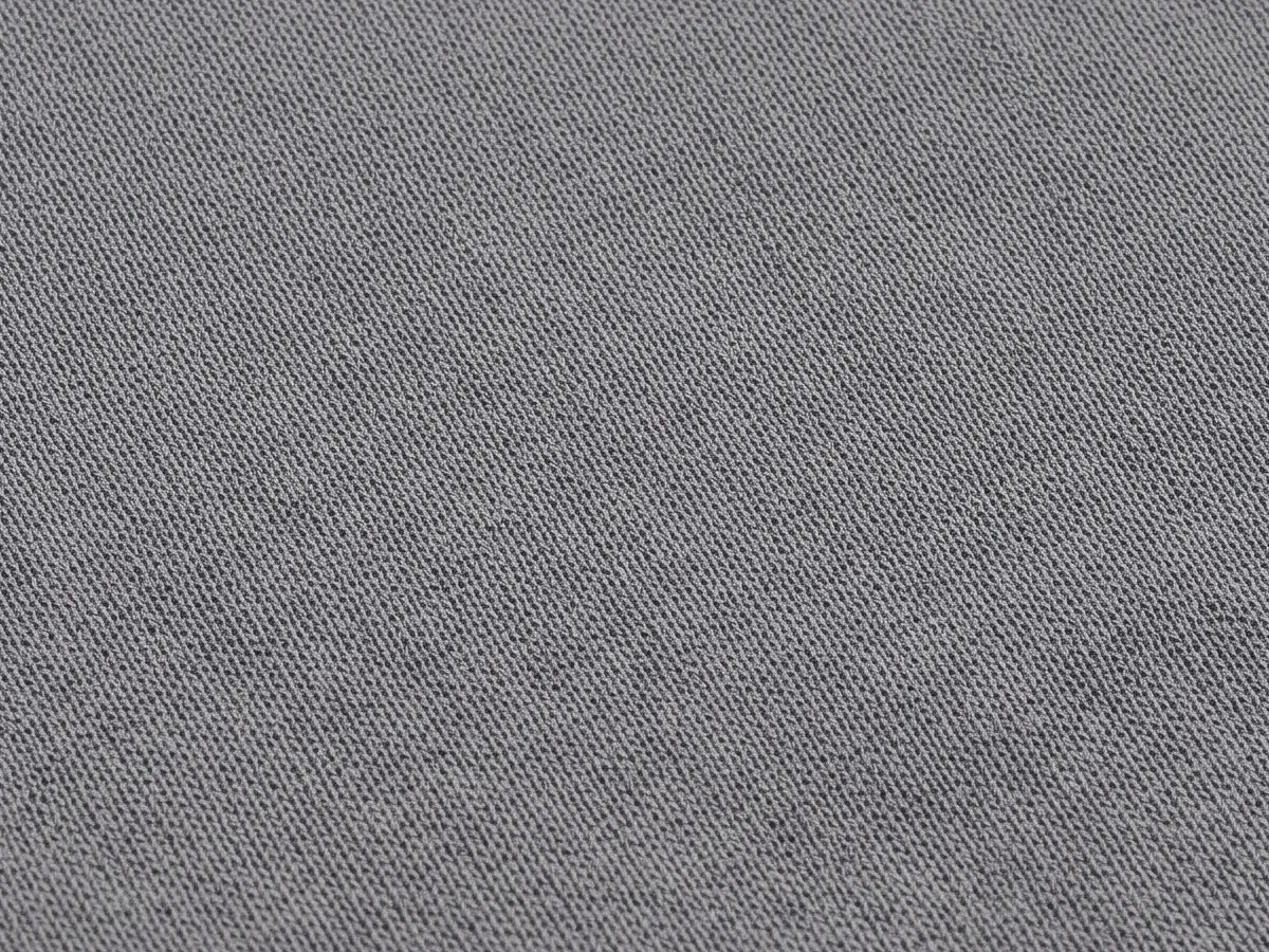 Close view of a mid-weight stretch body fabric face in a neutral oatmeal tone