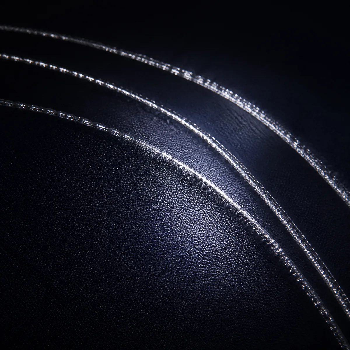 Same commuter jacket panel under headlight-equivalent light, reflective threading activated