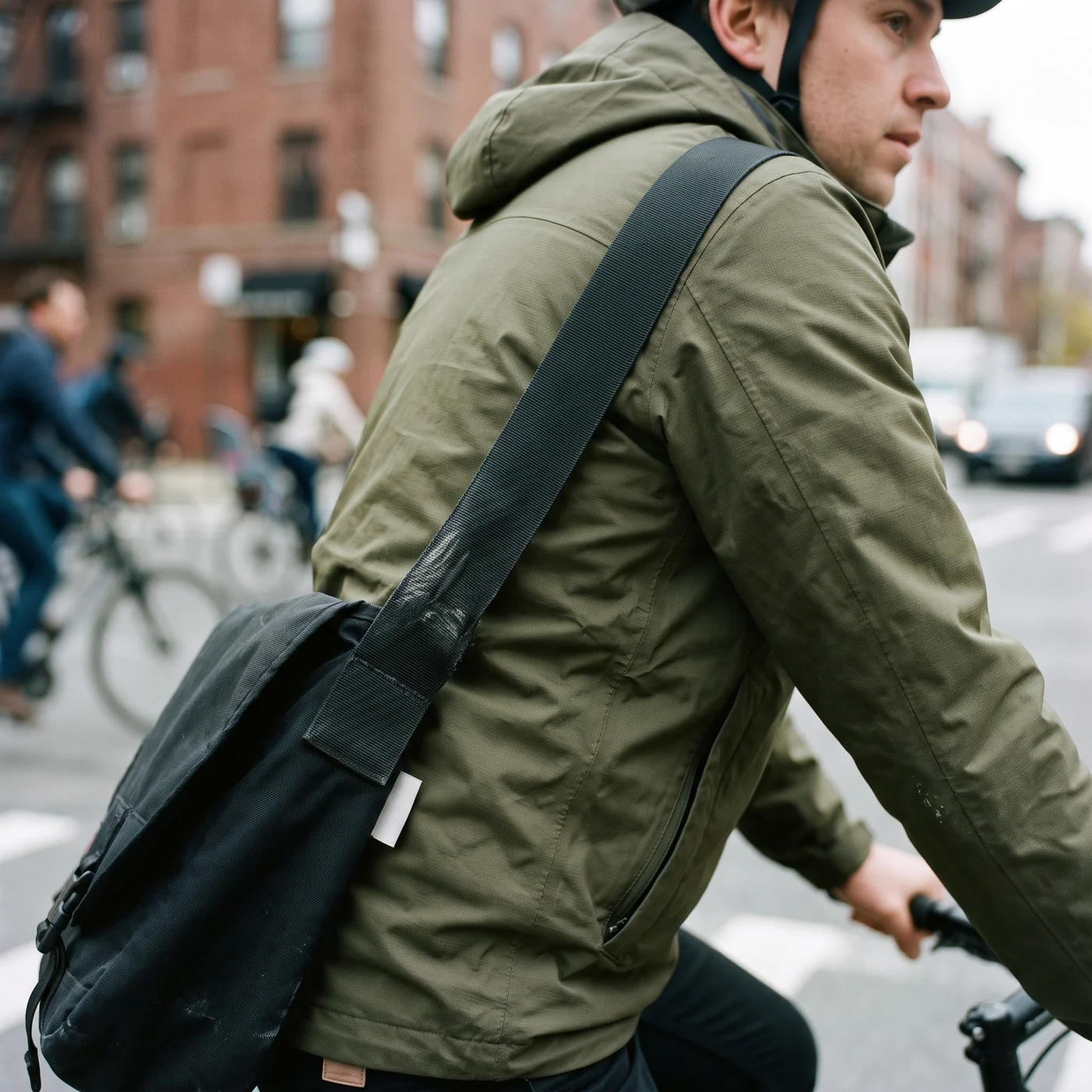 A shoulder strap bearing down across a garment panel on the move