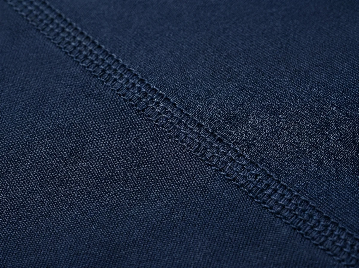 Flatlocked seam running clear of the contact area on a navy panel