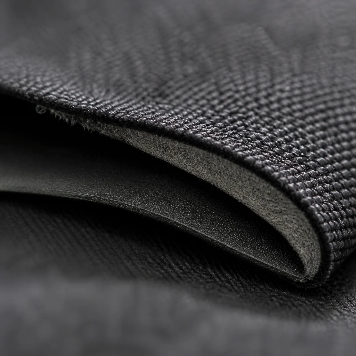 Close-up of a denser layered fabric structure, representing an outdoor cut's windproof laminate