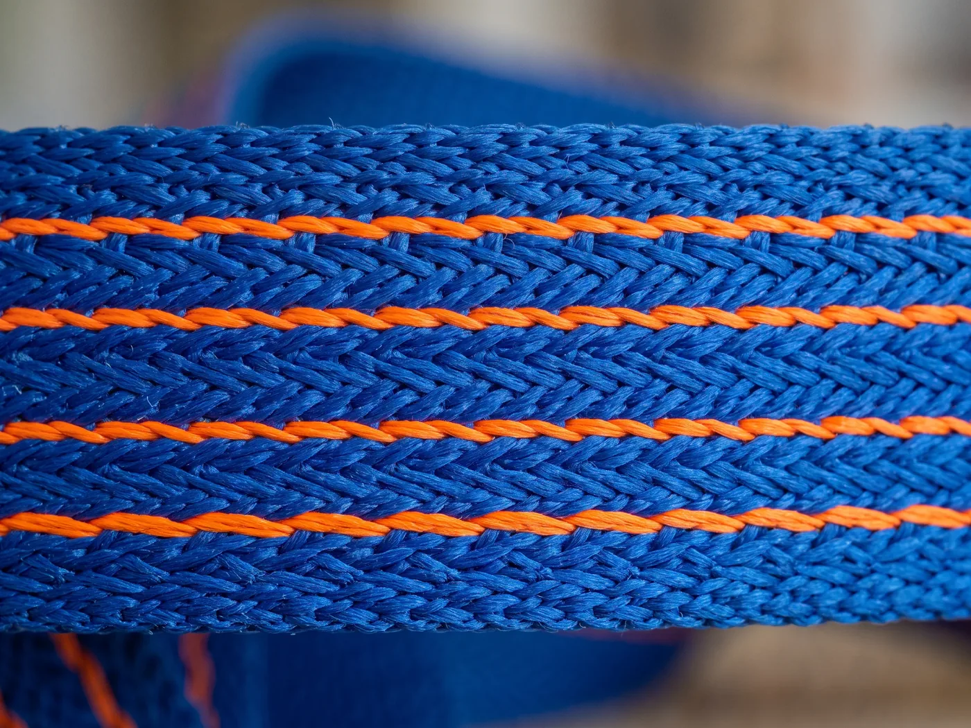 Blue woven webbing bonded with orange strands