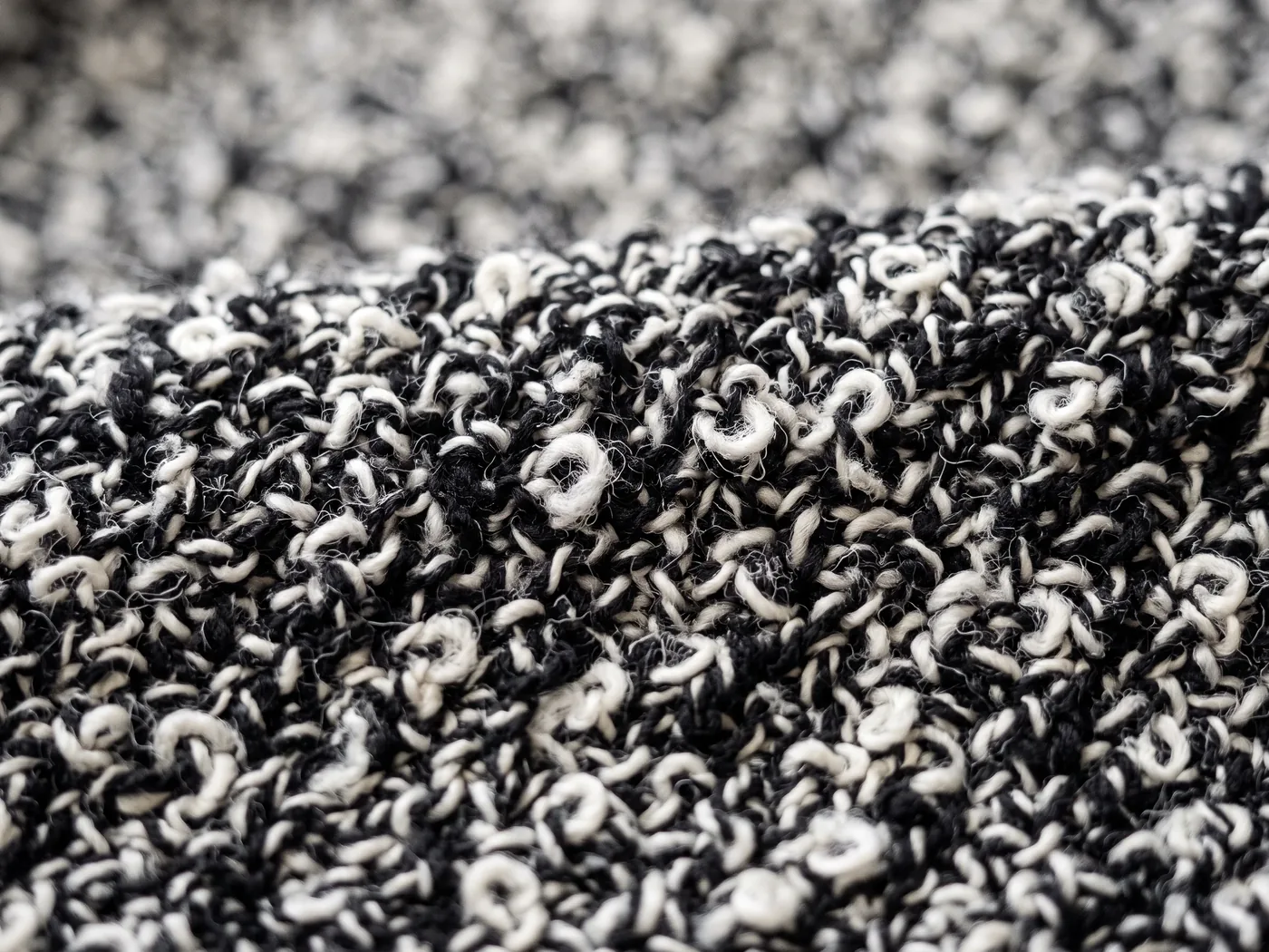 Macro of a black and white boucle knit structure