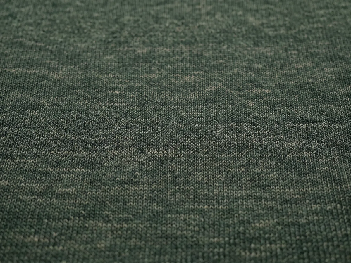Macro of a dark green marl jersey knit