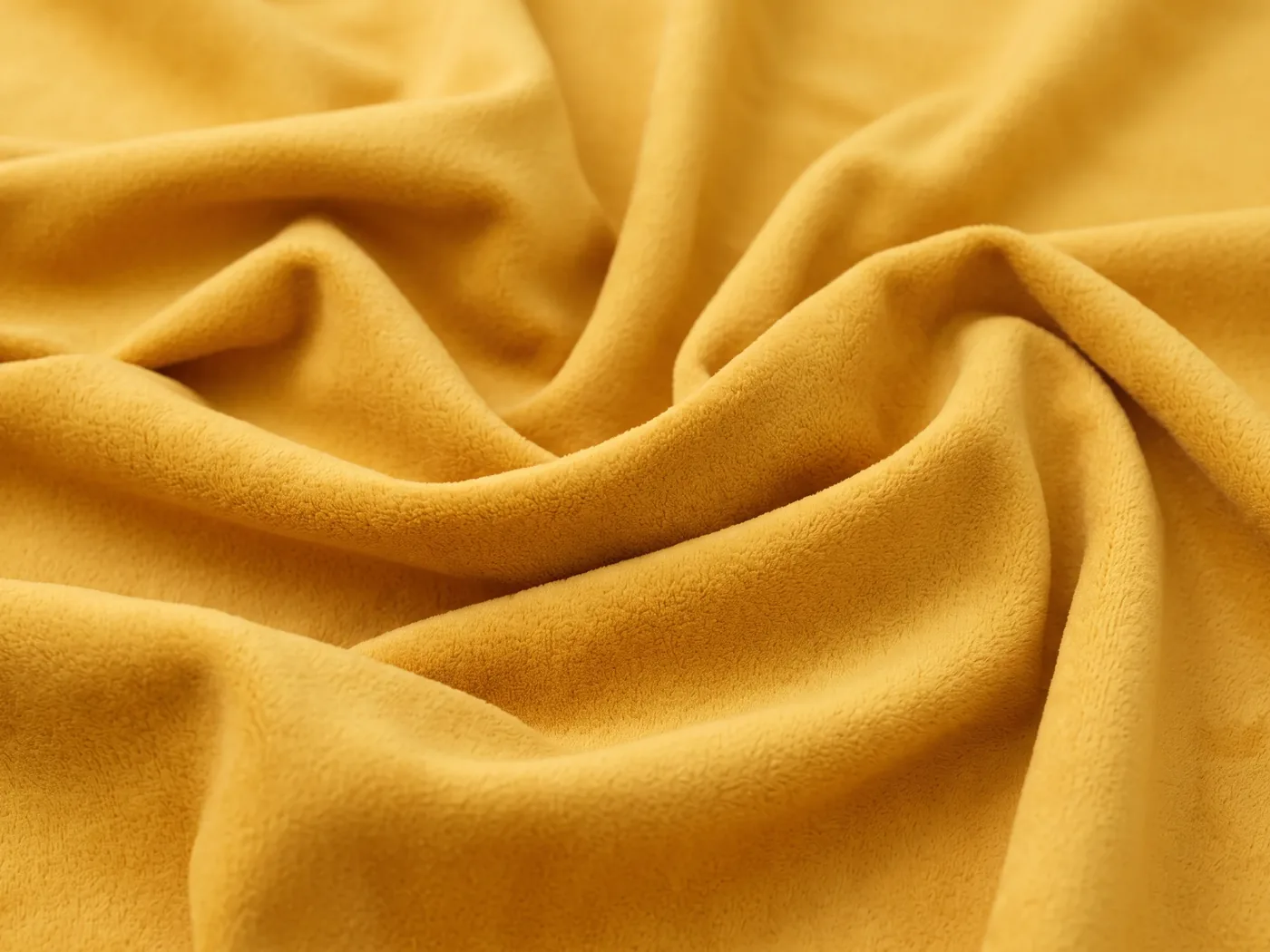 Folds of a golden-yellow brushed microfibre fabric