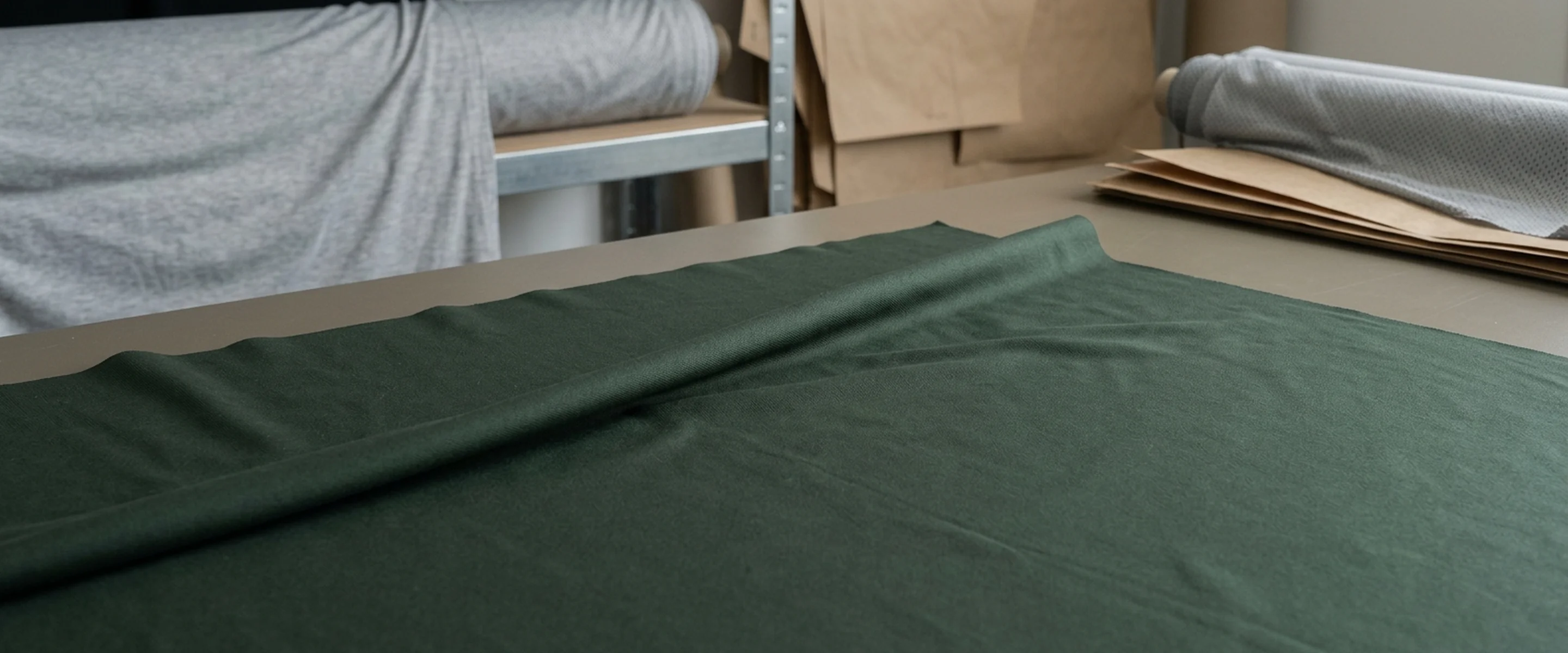 A wide plane of dark green knit with a single ridge lifting across it