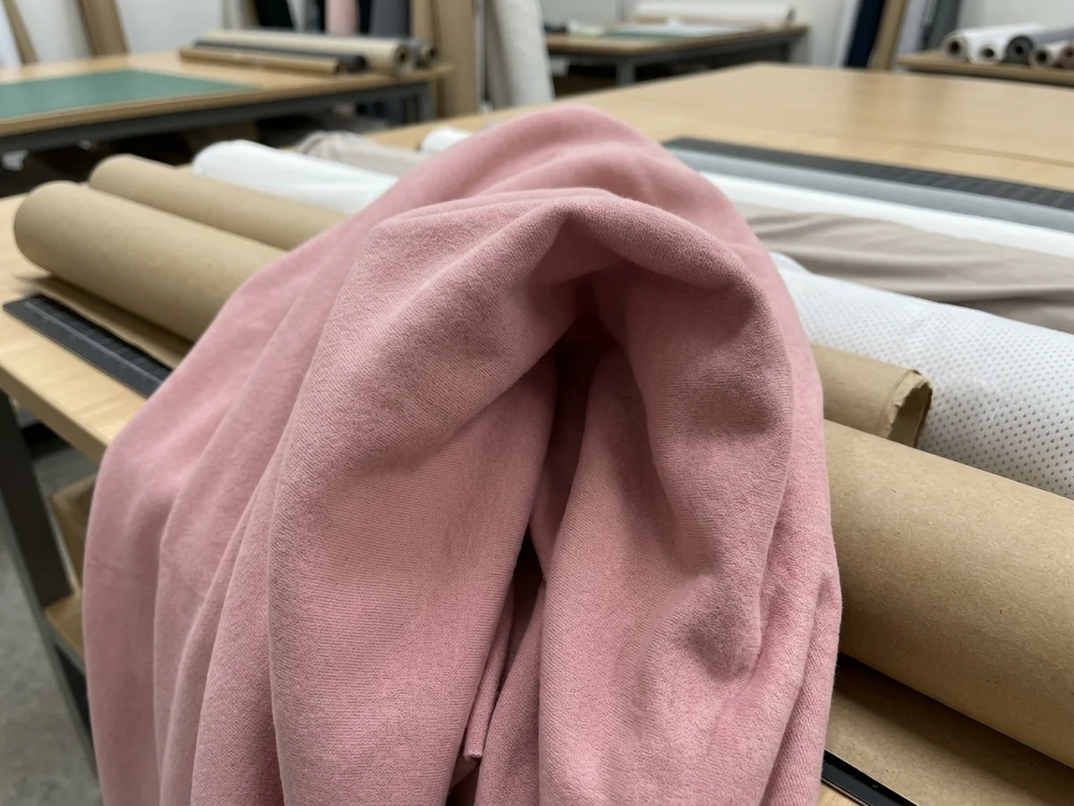 Macro of soft brushed pink knit falling into a deep fold